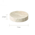 Travertine-look bathroom accessories set with soap dispenser, dish, and tray on a vanity.
