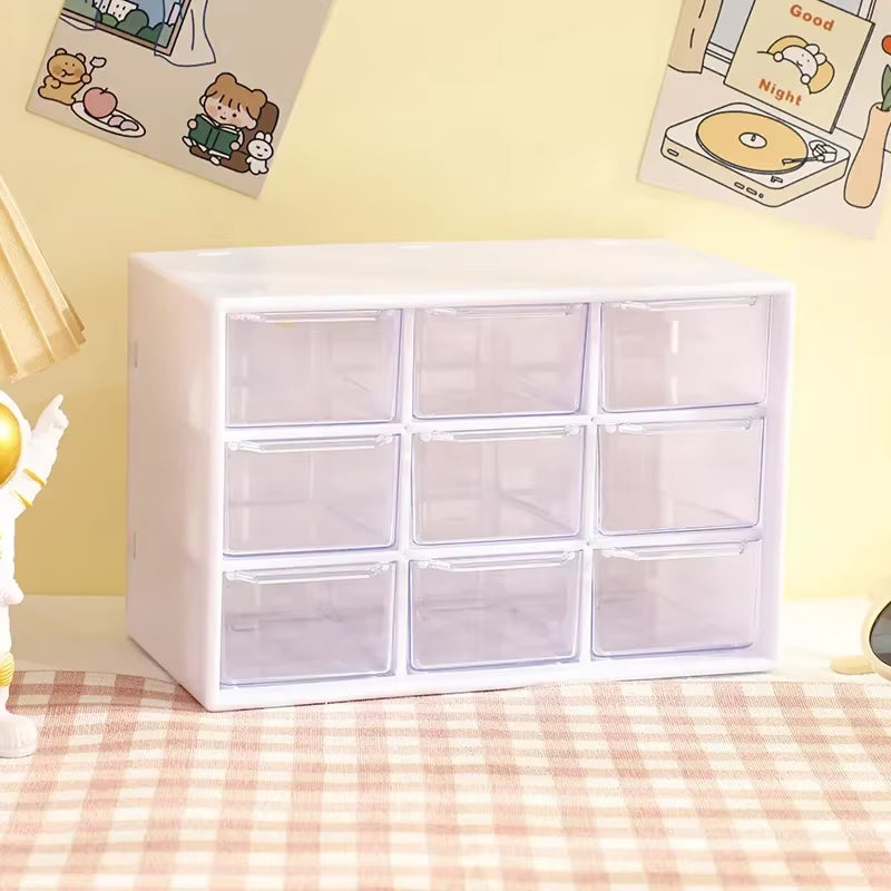 Nine-grid clear desk drawer organizer box sorting small items in a drawer.