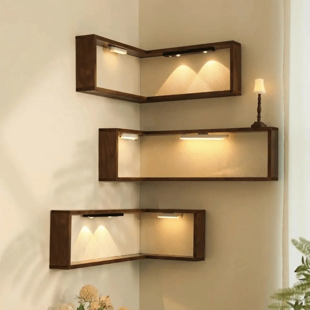 Wooden corner floating wall shelf mounted in a room corner holding decor.