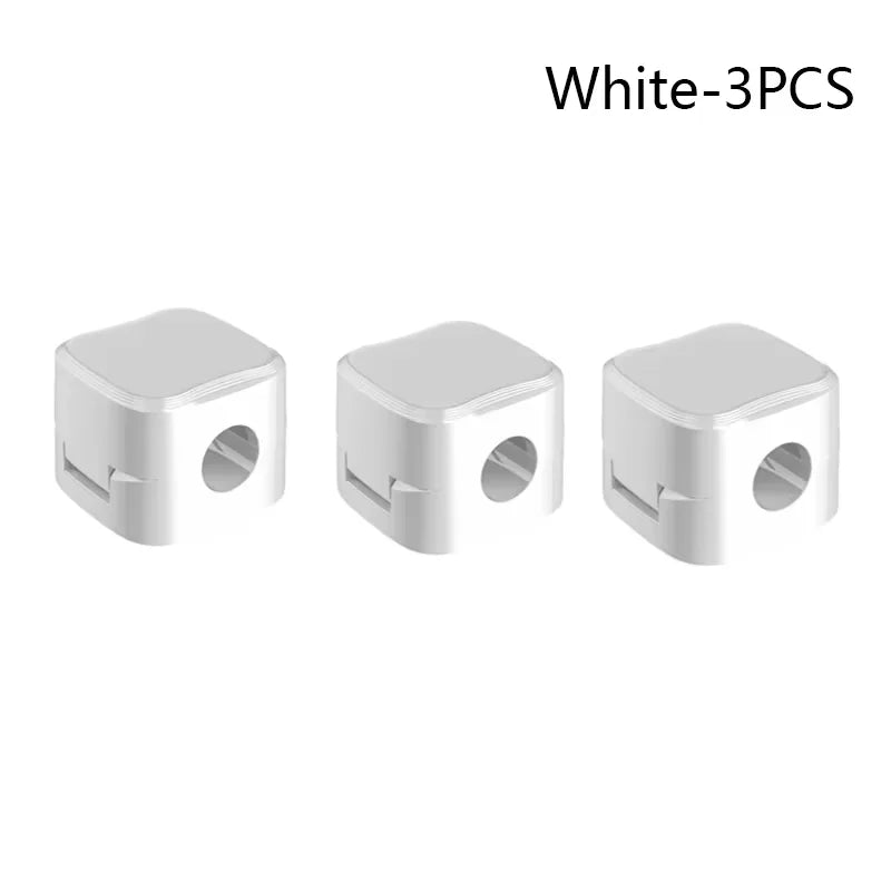 Stowhaus magnetic cable clips holding several cords neatly along the edge of a desk.