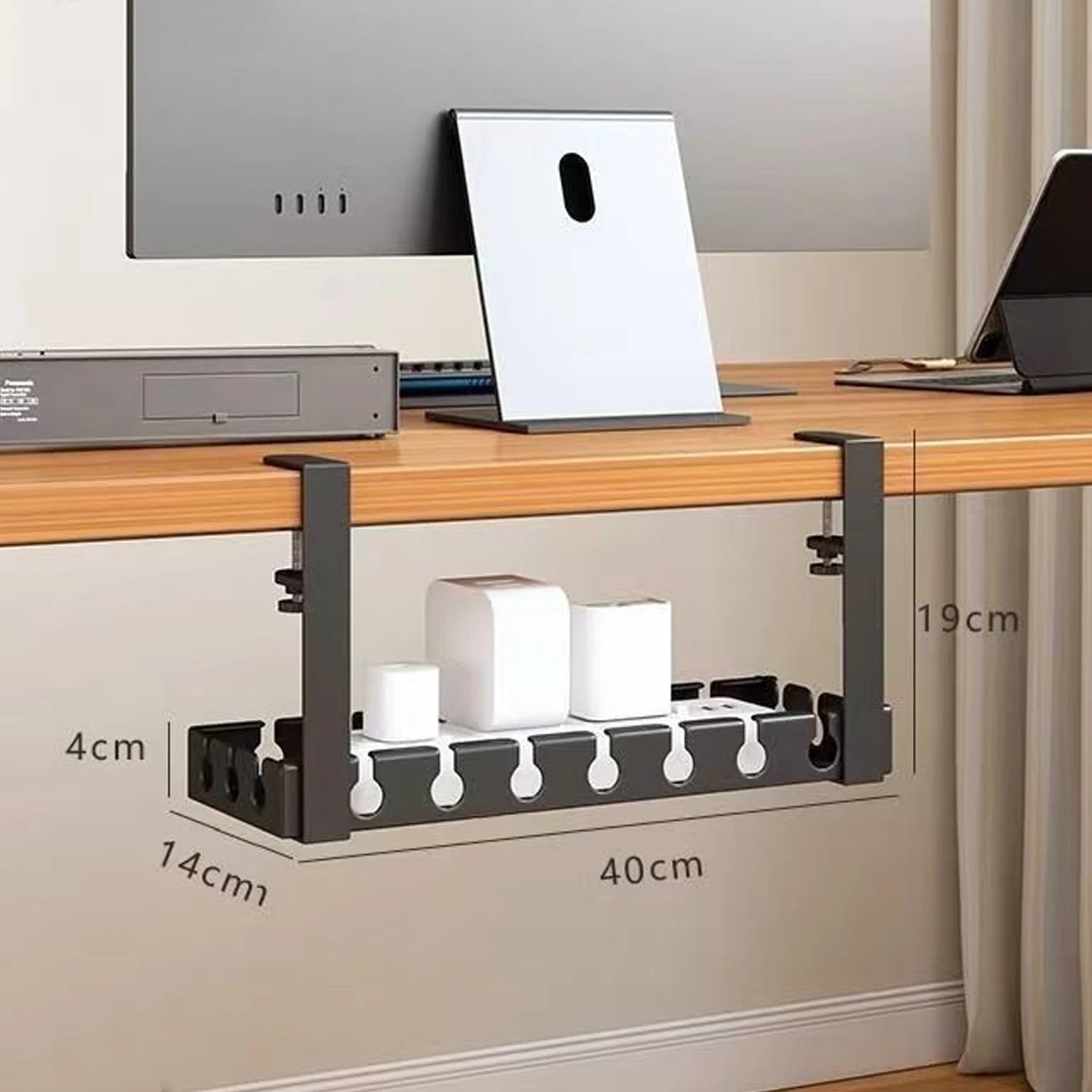 Iron under desk cable management tray holding a power strip and cords beneath a desk.