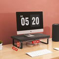 Monitor stand riser lifting a screen with storage drawers underneath on a desk.
