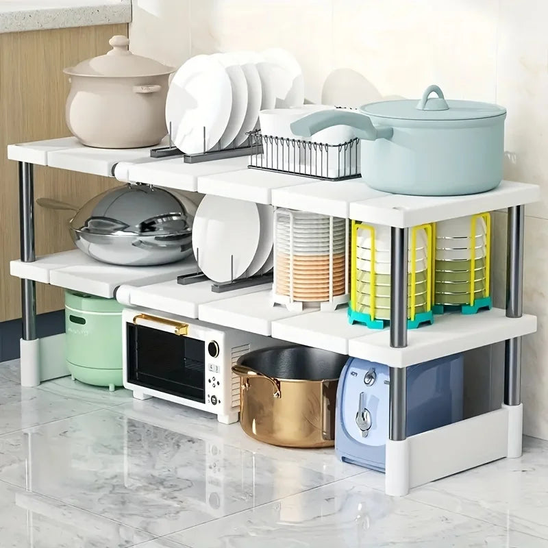 Expandable kitchen storage shelf holding pots, dishes and small appliances