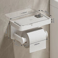Wall mount toilet paper holder with a phone shelf tray in a bathroom.